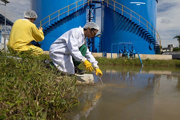 istock Water quality test, Environmental engineers wearing PPE sample inspect water quality , Industrial and environment 2234943903