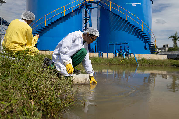 istock Water quality test, Environmental engineers wearing PPE sample inspect water quality , Industrial and environment 2234943906