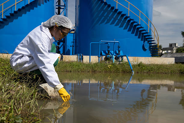 istock Water quality test, Environmental engineers wearing PPE sample inspect water quality , Industrial and environment 2234943943