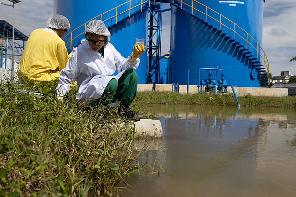 istock Water quality test, Environmental engineers wearing PPE sample inspect water quality , Industrial and environment 2234943951