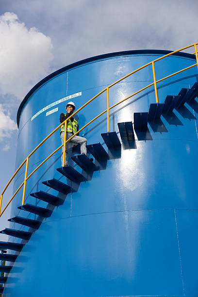 istock Water analysis or science in green and yellow protective clothing handle lab test equipment step up staircase of huge industrial Pulsator Clarifier Tank 2234944058