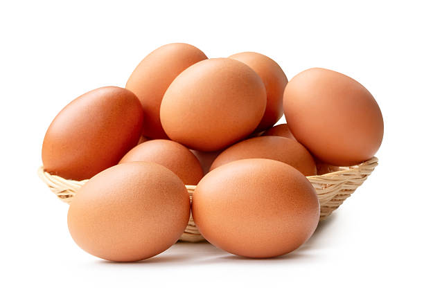 istock Many brown chicken eggs in stack in wicker basket isolated on white background with clipping path 2234944456