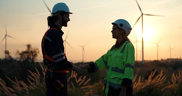istock Two maintenance engineers working in wind turbine farm. 2234947192