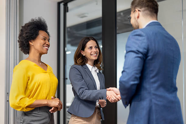 istock Businesswomen shaking hands in modern office welcoming new partner 2234948607