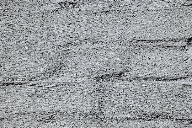 istock Cracked white painted brick wall for damaged building and repair concept 2234948962