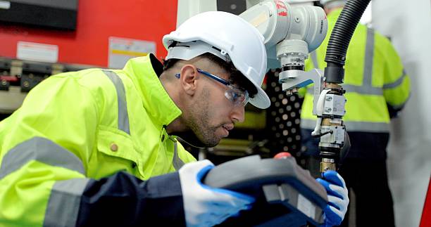 istock Two male technician worker maintenance automatic robotic hand in smart factory. 2234950211