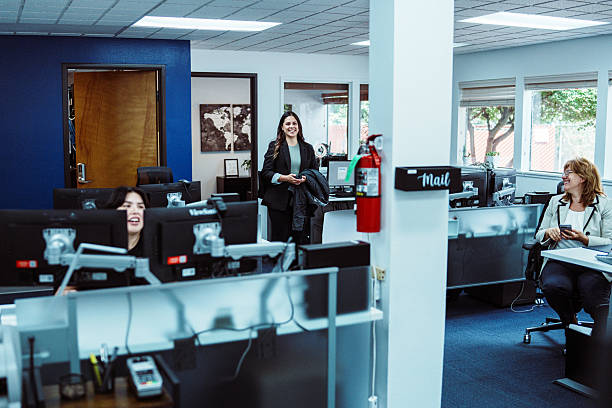 istock Executive greeting coworkers in office 2234952643