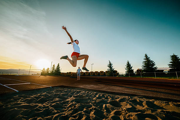 disabled athlete landing sand in long jump