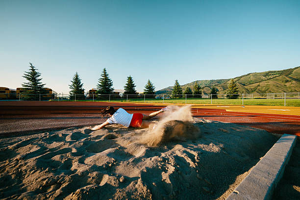 Young athlete practicing running and jumping outdoors