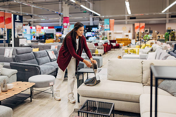 istock Asian woman evaluating fabric choices in a store with diverse sofa models on display. She is in the process of selecting the right fit 2234954568