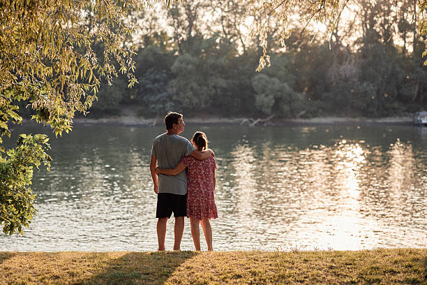 Senior couple enjoying a day on the river during sunset.