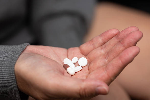 istock Close up of several pills in hand 2234958170