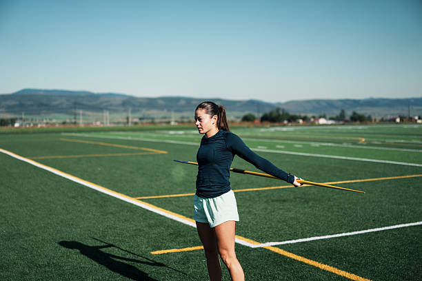 istock Latina Track Athlete Warming Up on Field 2234958380