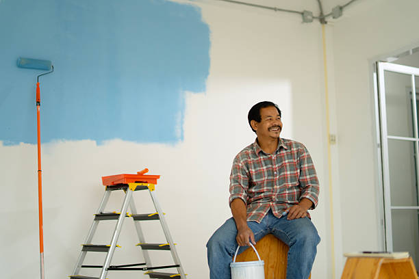 istock The painter is painting the house's wall. 2234958457