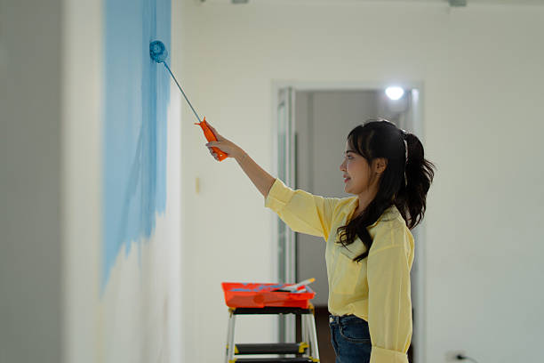 istock The painter is painting the house's wall. 2234958492