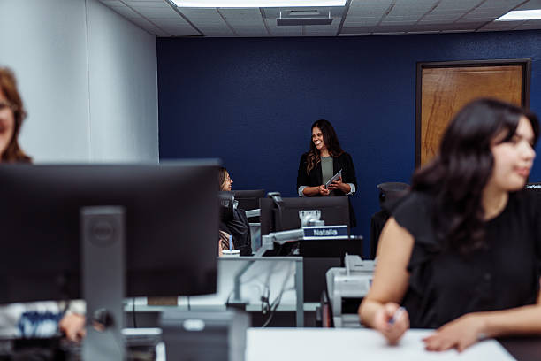istock Smiling female manager talking with employee 2234958603