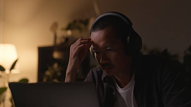 istock Exhausted Asian Man Feeling Stressed from Working Late at Office. 2234959398