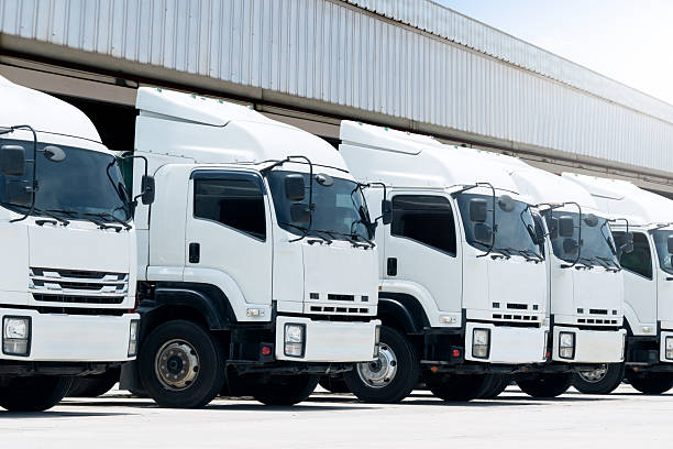 istock Semi Trailer Trucks on The Parking Lot at  Warehouse. Shipping Cargo Container. Trucks Loading Goods at Dock Warehouse. Distribution Warehouse. Big rig. Freight Logistics Truck Transport 2234959928