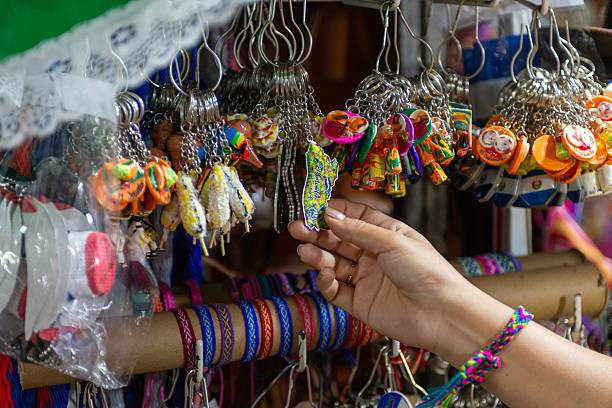 istock Hand selects a colorful El Salvador-shaped keyring from a display of vibrant, handcrafted souvenirs 2234960077
