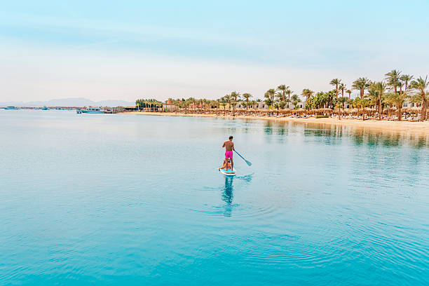 Photo from Hurghada in Egypt Father with sons on paddleboard. High quality photo