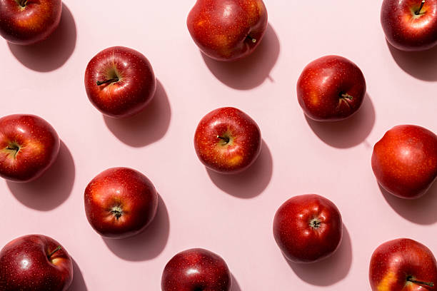 istock Many red apples on colored background, top view. Autumn pattern with fresh apple above view 2234965318