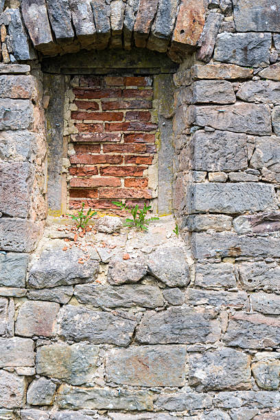istock medieval natural stone wall with bricked-up window 2234966088