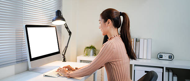 istock creating comfortable conditions for office workers. A young woman in office clothes is sitting at a computer desk in front of a large computer monitor screen. an empty space for the text. 2234967844