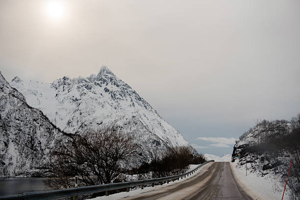 istock Snowy Mountain Road Under Cloudy Sky 2234969523
