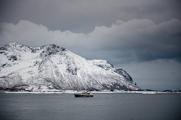 istock Boat Sailing by Snow-Covered Mountains 2234969533