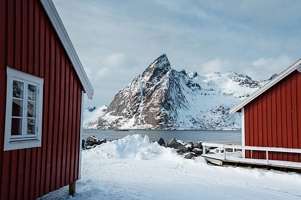 istock Red Cabins in Snowy Mountain Landscape 2234969663