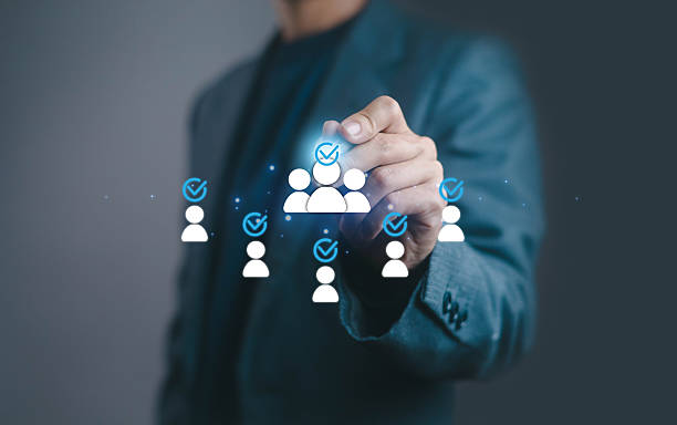 istock Businessman selecting digital people icons with check marks. Concept for recruitment, human resources, employee selection, online hiring, team building, and candidate evaluation. 2234969695