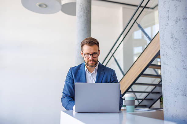 istock Businessman working on laptop in modern office 2234972062