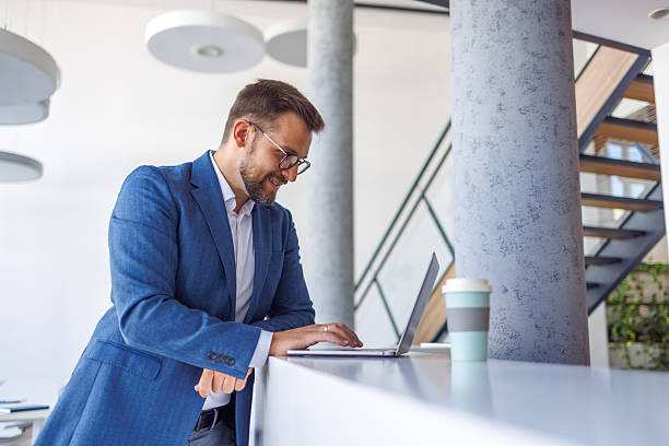 istock Happy businessman working on laptop in modern office 2234972089