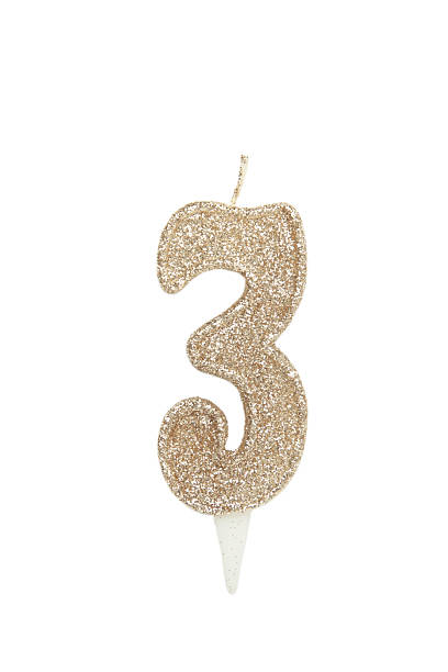istock Gold birthday candle isolated on white background. Number 3. 2234972428
