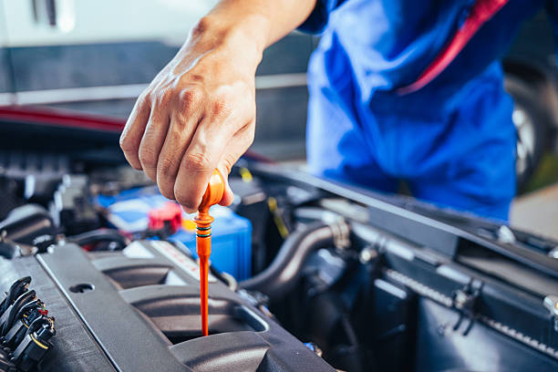 istock technician changing engine oil and performing vehicle service in a garage, professional auto mechanic work, tools and car parts, clean and organized workshop 2234972655