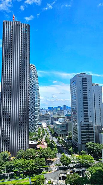 istock Sky view adorned with towering buildings, captured from below. The perspective showcases the majestic structures blending harmoniously with stunning clouds and a vibrant, clear sky. 2234974806
