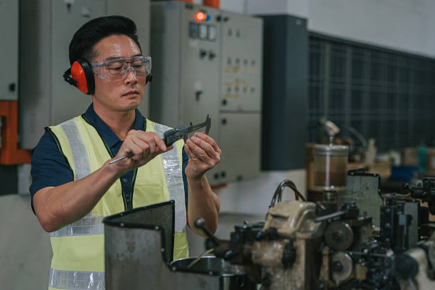 istock Asian factory worker using caliper for quality inspection in manufacturing facility 2234978913