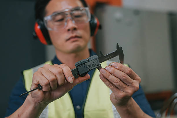 istock Close-up Asian factory worker using caliper for precision measurement 2234978983
