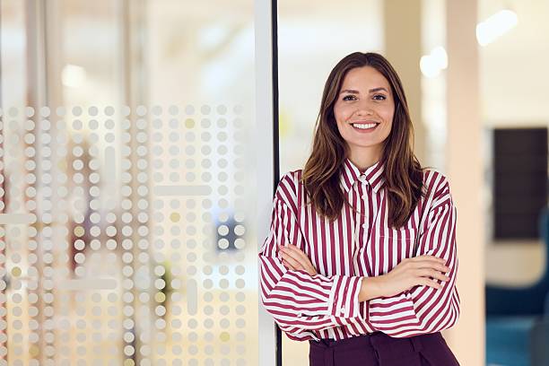 istock Confident Professional Woman Smiling in a Modern Office Environment 2234980086