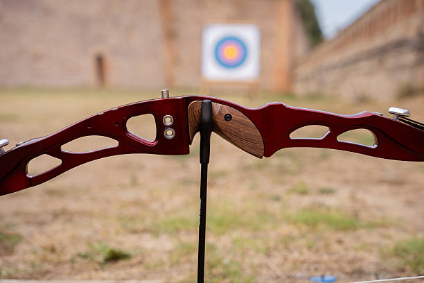 istock Compound bow placed on a stand on a grass field, aiming at a colorful target, ready for archery practice 2234981169