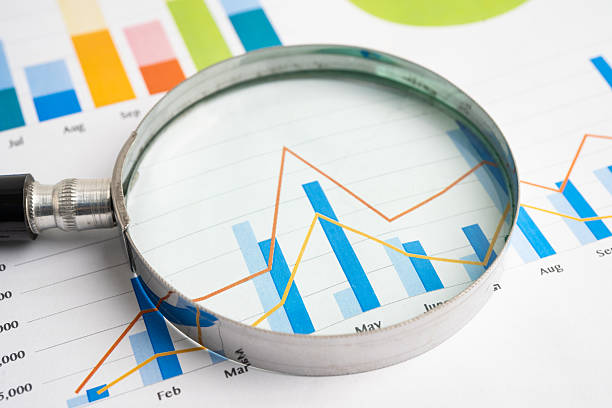 istock Magnifying glass on data business graphs paper. 2234981258