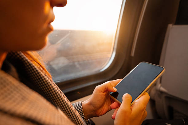 istock Female business commuter with smartphone on railway journey 2234982807