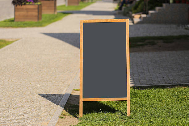 istock Empty chalkboard sign on sidewalk. Street board ready for restaurant or shop advertisement. 2234987936