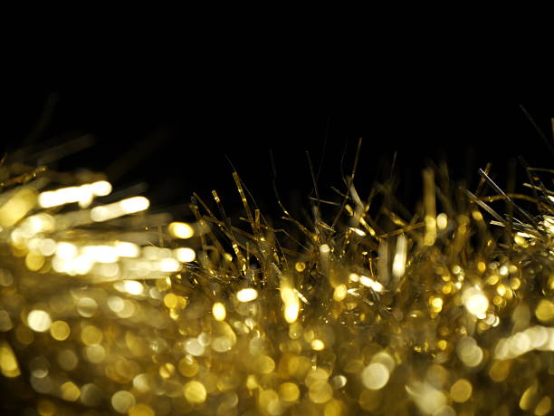 Festive golden color  tinsel as background  . Celebration backdrop, party decorations .
