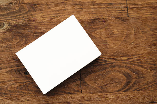 istock Blank businesscard stacks on rough wooden table 2234990435