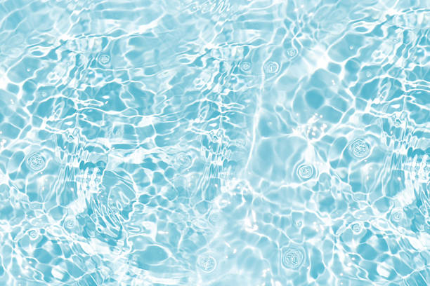 istock Blue water with ripples on the surface. Defocus blurred transparent blue colored clear calm water surface texture with splashes and bubbles. Water waves with shining pattern texture background. 2234992154
