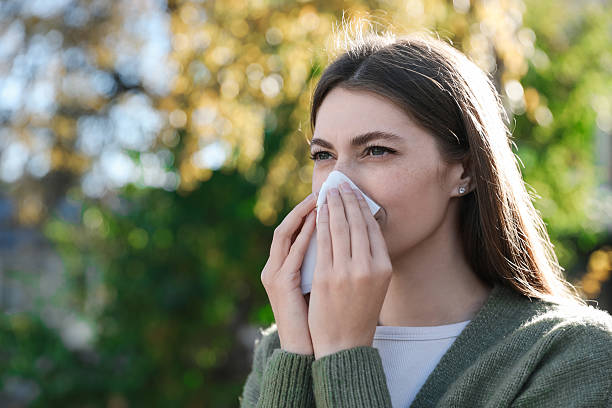 istock Woman with runny nose in park, space for text 2234993048