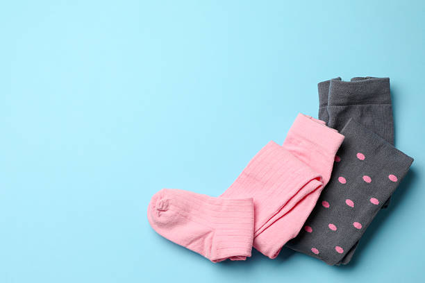 istock Different child's tights on light blue background, top view. Space for text 2234993121