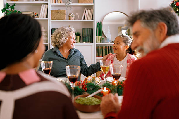 istock Young girl having a conversation with her grandma during Xmas dinner 2234994451