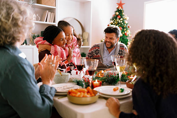 istock Daughter embraces mom with joy after opening holiday present. 2234994700